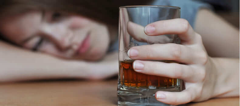 Женщина со стаканом алкоголя